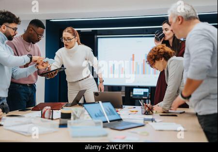 Diverse group of colleagues collaborating on business strategies Stock Photo