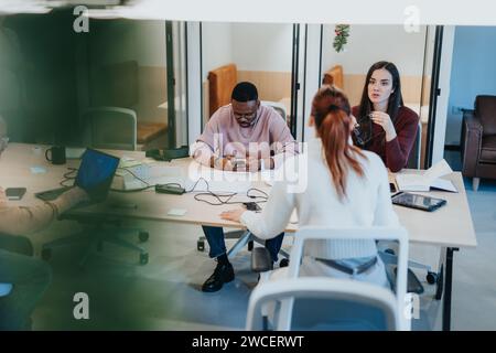 Business people working on completion of a project, demonstrating teamwork and positive outcomes. Stock Photo