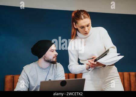 Young adult entrepreneurs working together in a corporate office, collaborating and strategizing for business expansion and profit growth. Stock Photo