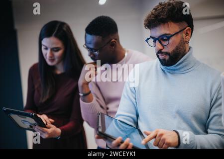 Multiracial professionals collaborating on business strategies, analyzing statistics, and working towards success in an innovative office environment. Stock Photo