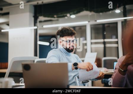 Business professionals collaborate, review statistics, and plan tasks in a pleasant office atmosphere. Stock Photo