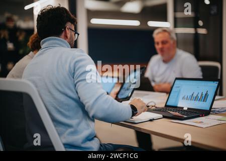Business professionals collaborate on business strategies and data analysis for revenue growth in a pleasant office environment. Stock Photo