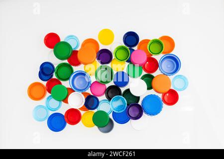 Plastic bottle caps of different colors for recycling - White background Stock Photo