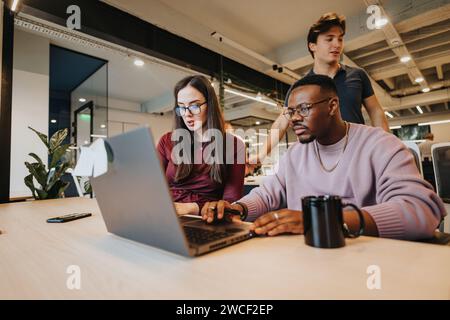 Multiracial team in creative office review financial reports, plan projects, and collaborate on growth strategies for their business. Stock Photo