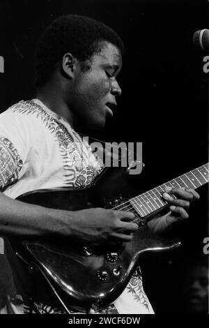 The Bhundu Boys perform at the first WOMAD weekender event at Carlyon Bay in Cornwall, England, in 1987. The Zimbabwean band, which played a type of music known as jit, became popular very quickly in the U.K. and Europe and played at Wembley Stadium in 1987 with Madonna. Pictured: Biggie Tembo, guitar and vocals. Stock Photo