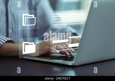 File system. Woman with laptop at table, closeup. User organizing folders and documents Stock Photo