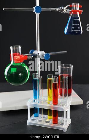 Laboratory glassware with liquids against black background Stock Photo ...