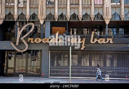 Downtown street scene with sign for the Broadway Bar and art deco architectural details in Los Angeles, California,USA Stock Photo