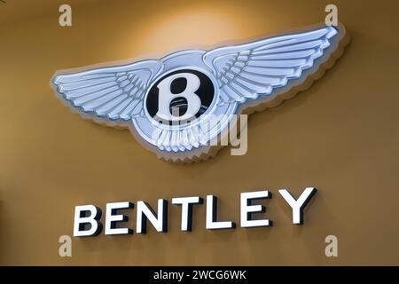 Logo Bentley on a gold background. Luxury hybrid motor car show in Thailand Bangkok 21 december 2023 Stock Photo