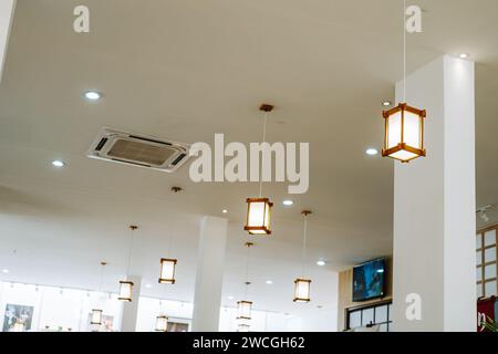 Modern interior with many wooden Japanese style pendant light. Stock Photo