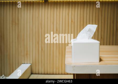 A tissue box on a wooden table with bokeh background in modern interior Stock Photo