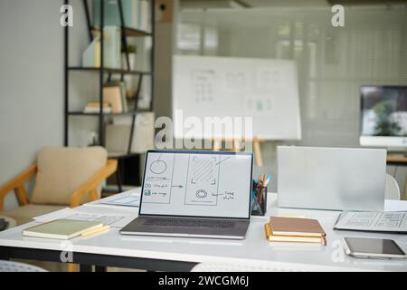 Laptop with mobile interface wireframe on screen, workplace of ui designer Stock Photo