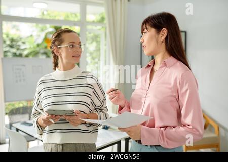 UX developer and graphic designer discussing mobile application update Stock Photo