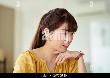 Portrait of young product manager working on laptop at her office desk Stock Photo