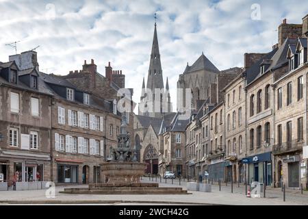 Guingamp, France - May 04 2022: The Plomée fountain with the Basilica of Notre-Dame de Bon-Secours behind. Stock Photo