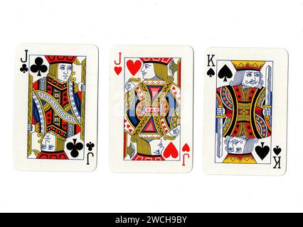 Vintage playing cards showing a pair of jacks and a king isolated on a white background. Stock Photo