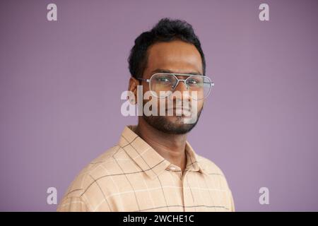Portrait of serious confident software developer in glasses looking at camera Stock Photo