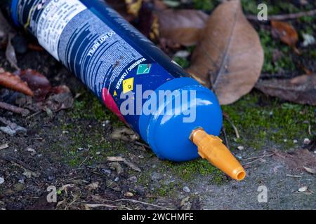 Empty large size gas cannister of nitrous oxide / laughing gas lying on the street on 1st December 2023 in Birmingham, United Kingdom. It has been reported that these large cannisters, which are now illegal, are being used by young people in particular, but the amount of gas which they are taking due to difficulty in guaging the amount taken, is creating long term negative health affects. Nitrous oxide, commonly known as laughing gas, nitrous, nitro, or NOS is now a very common legal high used by young people. The government updated the law to make possession of nitrous oxide illegal from 8 No Stock Photo