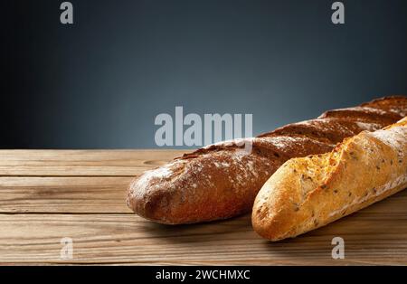 Buckwheat and wheat baguettes on a wooden table. Stock Photo