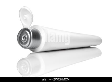 Open white tube for cream, toothpaste, gel or for cosmetics. Isolated on white. Stock Photo