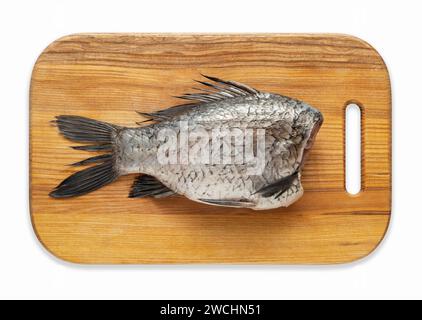 Peeled and chopped carp on a kitchen wood board Stock Photo