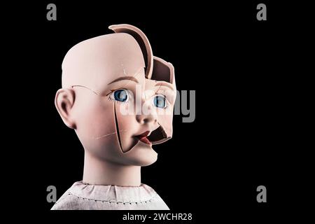 Broken vintage doll head isolated on black background with clipping path Stock Photo