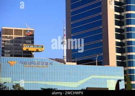 Statue of Policeman carrying Yellow School bus on top of the Police Headquarters in Seoul, South Korea. Stock Photo