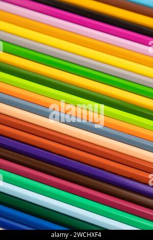 Set of watercolor pencils on brown wooden background. Top view, flat lay, close up Stock Photo