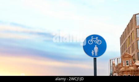 UK Road sign cycle and pedestrian pathway against a blue cloudy sky Stock Photo