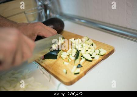 Caucasian man cutting zucchini. Domestic Kitchen Stock Photo