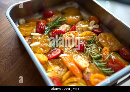 Red and yellow Tomatoes prepared with mediterranean Herbs Stock Photo