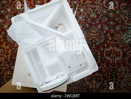 Paris, France - Nov 15, 2023: A professional unboxing of the Mi Smart LED Desk Lamp Pro, showcasing the process on a living room carpet. Discover the elegance and innovation inside. Stock Photo
