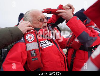 Laboe, Germany. 16th Jan, 2024. Peter David 'Pete' Sage from the North German band 'Santiano' and honorary ambassador of the sea rescuers puts on a lifejacket on board the rescue cruiser 'Berlin'. Last year, German sea rescuers from the German Maritime Search and Rescue Service (DGzRS) on the North Sea and Baltic Sea helped a total of 3,532 people in 1938 missions. They had to rescue 103 people from distress at sea alone, as the DGzRS announced on Tuesday. (To dpa 'Sea rescuers help more than 3,500 people in the North and Baltic Seas') Credit: Marcus Brandt/dpa/Alamy Live News Stock Photo