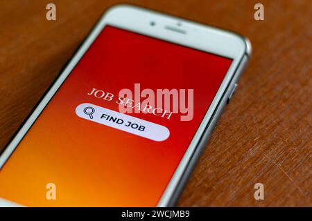 Job Search Concept. Smartphone with job search app on screen. Browsing job opportunities online. Stock Photo