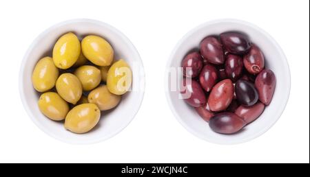 Green and Kalamata olives with pit, pickled whole, large Greek table olives, in white bowls. Stock Photo