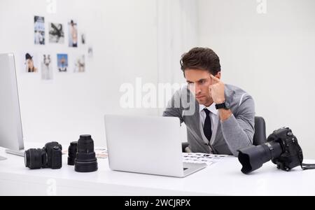 Photographer, working and editing on computer in office with technology, software and thinking. Professional, editor and creative person learning on Stock Photo