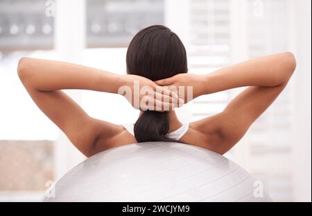 Fitness, workout and woman with gym ball, sports and energy for health, wellness and training challenge. Exercise, pilates and girl with equipment for Stock Photo