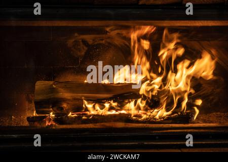 Detail of a home fireplace with burning wood. Stock Photo