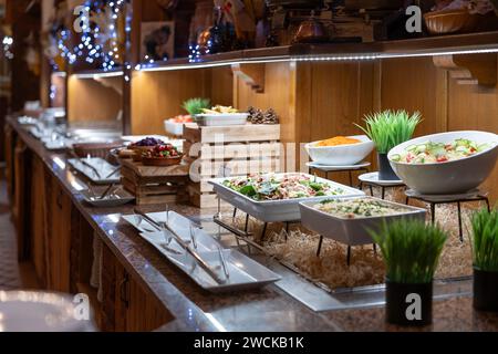 Buffet table full of dishes and salads ready for dinner for hotel guests. Stock Photo