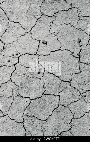 Black and white cracked wall with small stones Stock Photo