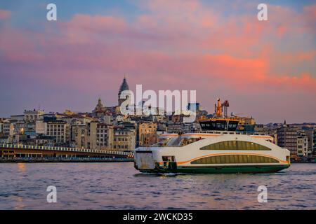 Sunrise cityscape of the Karakoy area across Bosphorus Strait by Galata Bridge with the Galata Tower at the golden hour of sunrise in Istanbul, Turkey Stock Photo