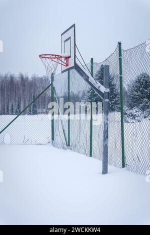 Outdoors basketball court covered with snow in winter, Finland. Stock Photo