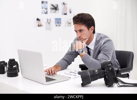 Photographer, thinking and editing on computer in office with technology, software and work. Professional, editor and creative person learning on Stock Photo