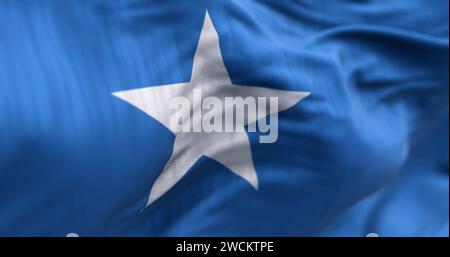 Close-up view of Somalia national flag waving in the wind. Light blue field with a single white, five-pointed star at the center. Fabric textured back Stock Photo