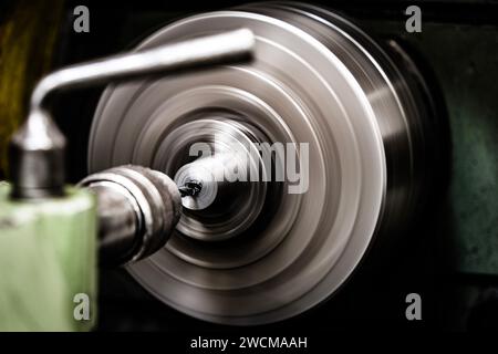 An old green lathe machine in a workshop Stock Photo