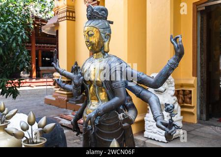 Ancient statue of Guanyin, Guan Yin or Kuan Yin. It is the Buddhist bodhisattva associated with compassion. Decoration of Buddhist temple, Sri Lanka, Stock Photo