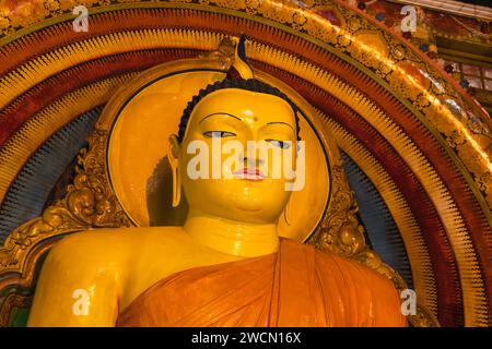 Face of the Buddha statue of the Gangaramaya temple, one of the biggest Buddhist temples of Colombo, the capital city of Sri Lanka Stock Photo