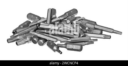Pile of steel screwdriver bits of different type and size isolated on a white background. Kit of interchangeable security torx and hex screw drivers. Stock Photo
