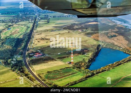 Railway tracks lead through meadows and fields, Morsum Teich Noesse Kuhle and transmission mast, NDR radio station, aerial view, Sylt, Germany Stock Photo