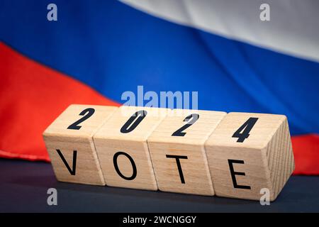 Russia vote 2024, Wooden blocks written vote 2024, Russian flag in the background. Concept of elections and voting in Russia Stock Photo